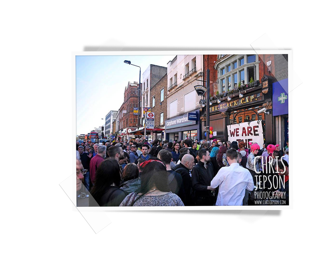 A street full of people in front of the Black Cap in Camden London