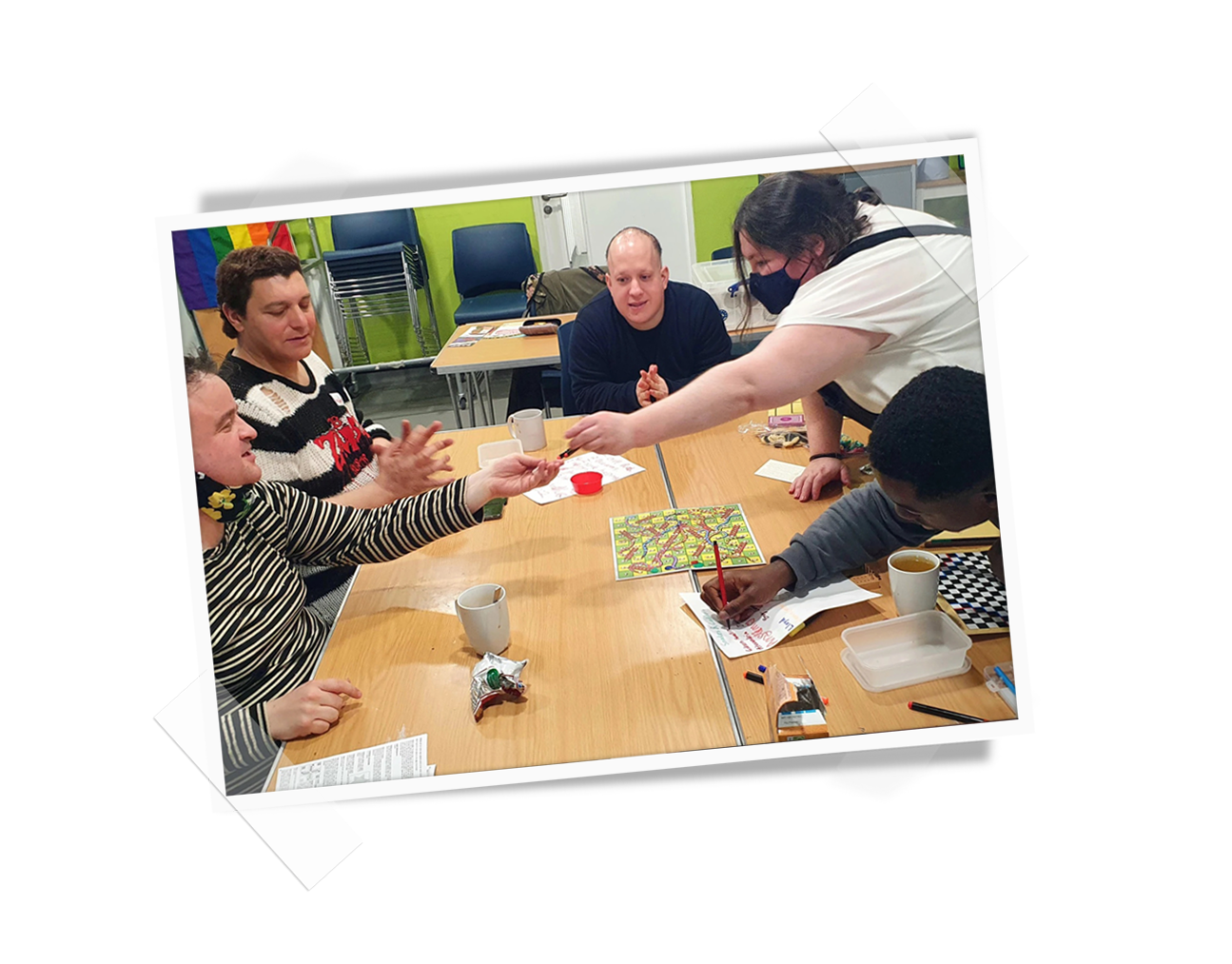 A group of people sat round a table enjoying the Creative Hubs facilities